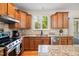 Updated kitchen with stainless steel appliances, stone backsplash, granite countertops and window with lots of natural light at 3729 Norman Blalock Rd, Willow Springs, NC 27592