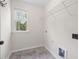 Laundry room featuring a window with natural light, vinyl flooring and wire rack shelving at 3729 Norman Blalock Rd, Willow Springs, NC 27592