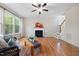 Bright living room with hardwood floors, fireplace, and large windows offering ample natural light at 3729 Norman Blalock Rd, Willow Springs, NC 27592