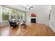 Cozy living room boasts hardwood floors, a fireplace, and large windows overlooking greenery at 3729 Norman Blalock Rd, Willow Springs, NC 27592