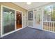 Covered porch with screens and sliding glass doors offers views of the backyard and kitchen access at 3729 Norman Blalock Rd, Willow Springs, NC 27592