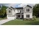 Charming two-story home featuring a two-car garage, stylish siding, and a welcoming front porch at 3836 Lebrun Path # 140 Lassen Cr, Fuquay Varina, NC 27526