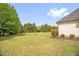Spacious backyard with lush lawn and mature trees, offering privacy and room for recreation at 432 Kings Hollow Dr, Raleigh, NC 27603