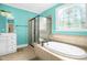 Full bathroom features an enclosed shower and soaking tub beneath a stain glass window at 432 Kings Hollow Dr, Raleigh, NC 27603