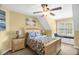 Comfortable bedroom with a ceiling fan, window bench seat, and coordinated furnishings at 432 Kings Hollow Dr, Raleigh, NC 27603