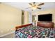 Bedroom featuring a dark wood bed frame, ceiling fan, and natural light at 432 Kings Hollow Dr, Raleigh, NC 27603