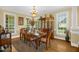 Elegant dining room with a chandelier, hardwood floors, and large windows offering natural light at 432 Kings Hollow Dr, Raleigh, NC 27603