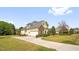View of the home's side exterior and driveway, highlighting the architectural style and curb appeal at 432 Kings Hollow Dr, Raleigh, NC 27603