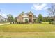 Attractive two-story home with manicured lawn and landscaping showcasing the home's architectural design at 432 Kings Hollow Dr, Raleigh, NC 27603