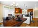 View of the kitchen leading to the dining area with dark wood table and decoratively set table at 432 Kings Hollow Dr, Raleigh, NC 27603