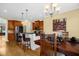 Spacious kitchen featuring a breakfast bar with dark granite countertops and wood cabinets at 432 Kings Hollow Dr, Raleigh, NC 27603