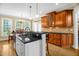 Charming kitchen featuring a breakfast bar with sink, stainless appliances, and wood cabinetry at 432 Kings Hollow Dr, Raleigh, NC 27603