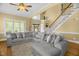 Inviting living room featuring hardwood floors, a large sectional sofa, and staircase at 432 Kings Hollow Dr, Raleigh, NC 27603