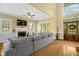 Comfortable living room with hardwood floors, fireplace, and a large sectional sofa for relaxation and entertainment at 432 Kings Hollow Dr, Raleigh, NC 27603