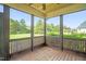 Screened porch with wooden floors and views of the landscaped backyard, providing a serene retreat at 432 Kings Hollow Dr, Raleigh, NC 27603