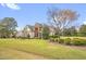Well-maintained home with a lush green lawn, mature trees, and manicured shrubbery at 432 Kings Hollow Dr, Raleigh, NC 27603
