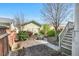 Charming backyard showing a brick pathway leading to a detached garage, surrounded by lush greenery and trees at 45 Summersweet Ln, Chapel Hill, NC 27516
