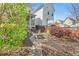 View of a backyard featuring a brick path leading to the home with vibrant trees and bushes at 45 Summersweet Ln, Chapel Hill, NC 27516
