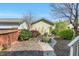 Private backyard featuring a brick path and a garden with various bushes and trees on a sunny day at 45 Summersweet Ln, Chapel Hill, NC 27516
