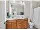 Well-lit bathroom featuring a double sink vanity, a large framed mirror, and a shower with a white curtain at 45 Summersweet Ln, Chapel Hill, NC 27516