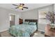 Bright bedroom with a ceiling fan, window blinds, and a wooden bed frame with an elaborate headboard at 45 Summersweet Ln, Chapel Hill, NC 27516