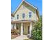Charming two-story home with a covered front porch, lush greenery, and a well-maintained lawn at 45 Summersweet Ln, Chapel Hill, NC 27516