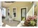 Inviting covered front porch with chairs and a decorative front door at 45 Summersweet Ln, Chapel Hill, NC 27516
