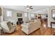 Relaxing living area with hardwood floors connecting to the dining room, offering ample seating and natural light at 45 Summersweet Ln, Chapel Hill, NC 27516