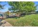 Playground with swings, slides, climbing structures, and mature trees in a grassy park setting at 45 Summersweet Ln, Chapel Hill, NC 27516
