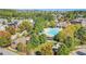 Aerial view of Briar Club swimming pool with slide, playground, and lush green landscaping at 45 Summersweet Ln, Chapel Hill, NC 27516