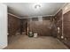 Unfinished basement featuring exposed brick, carpeted floors, and ceiling light fixture at 518 N Gutherie Ave, Durham, NC 27703