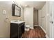 Bathroom with toilet, sink, damaged vanity and access to other rooms at 518 N Gutherie Ave, Durham, NC 27703
