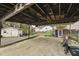 Attached carport features storage shed, gravel driveway, and access to back of home at 518 N Gutherie Ave, Durham, NC 27703
