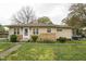 Cozy single-story home with vinyl siding, white trim, and well-maintained lawn at 518 N Gutherie Ave, Durham, NC 27703