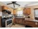 Cozy kitchen with wood cabinets, tile floors, and appliances at 518 N Gutherie Ave, Durham, NC 27703