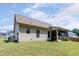 Spacious backyard featuring green grass and a screened in patio at 53 Azul Dr, Clayton, NC 27520