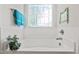 Bright bathroom featuring a soaking tub beneath a stained glass window with a decorative plant at 53 Azul Dr, Clayton, NC 27520