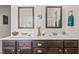 Bathroom with dual sinks, framed mirrors, and dark wood cabinetry at 53 Azul Dr, Clayton, NC 27520