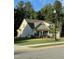 A two story home with stone accents and two car garage sits on a well manicured lawn at 53 Azul Dr, Clayton, NC 27520