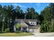 Charming single-Gathering home featuring a manicured lawn, stone accents and mature landscaping at 53 Azul Dr, Clayton, NC 27520