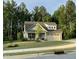 A well manicured yard features a beautiful house with stone accents and 2-car garage at 53 Azul Dr, Clayton, NC 27520