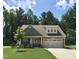 Charming home featuring a well-manicured lawn, a two car garage, and stone accents at 53 Azul Dr, Clayton, NC 27520