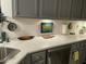 Bright kitchen featuring light gray cabinetry, white countertops, and stainless steel dishwasher at 53 Azul Dr, Clayton, NC 27520
