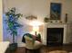 Cozy sitting area with a fireplace, accent chair, and elegant decor at 53 Azul Dr, Clayton, NC 27520
