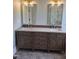 Double sink vanity with ornate detailing and gold fixtures adds elegance to the well appointed bathroom at 5480 Thom Rd, Mebane, NC 27302