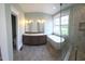 This bathroom features double sinks, gold fixtures, a soaking tub, and a frameless shower at 5480 Thom Rd, Mebane, NC 27302