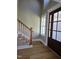 Inviting entryway with hardwood floors and a staircase near a charming front door at 5480 Thom Rd, Mebane, NC 27302