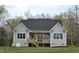 Charming home featuring a wooden deck overlooking expansive greenery at 5480 Thom Rd, Mebane, NC 27302