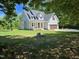 Charming two-story home with a covered front porch, lush green lawn, and attached two-car garage at 5480 Thom Rd, Mebane, NC 27302