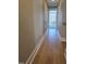 Hallway featuring hardwood floors that leads to a bright, naturally lit room at 5480 Thom Rd, Mebane, NC 27302
